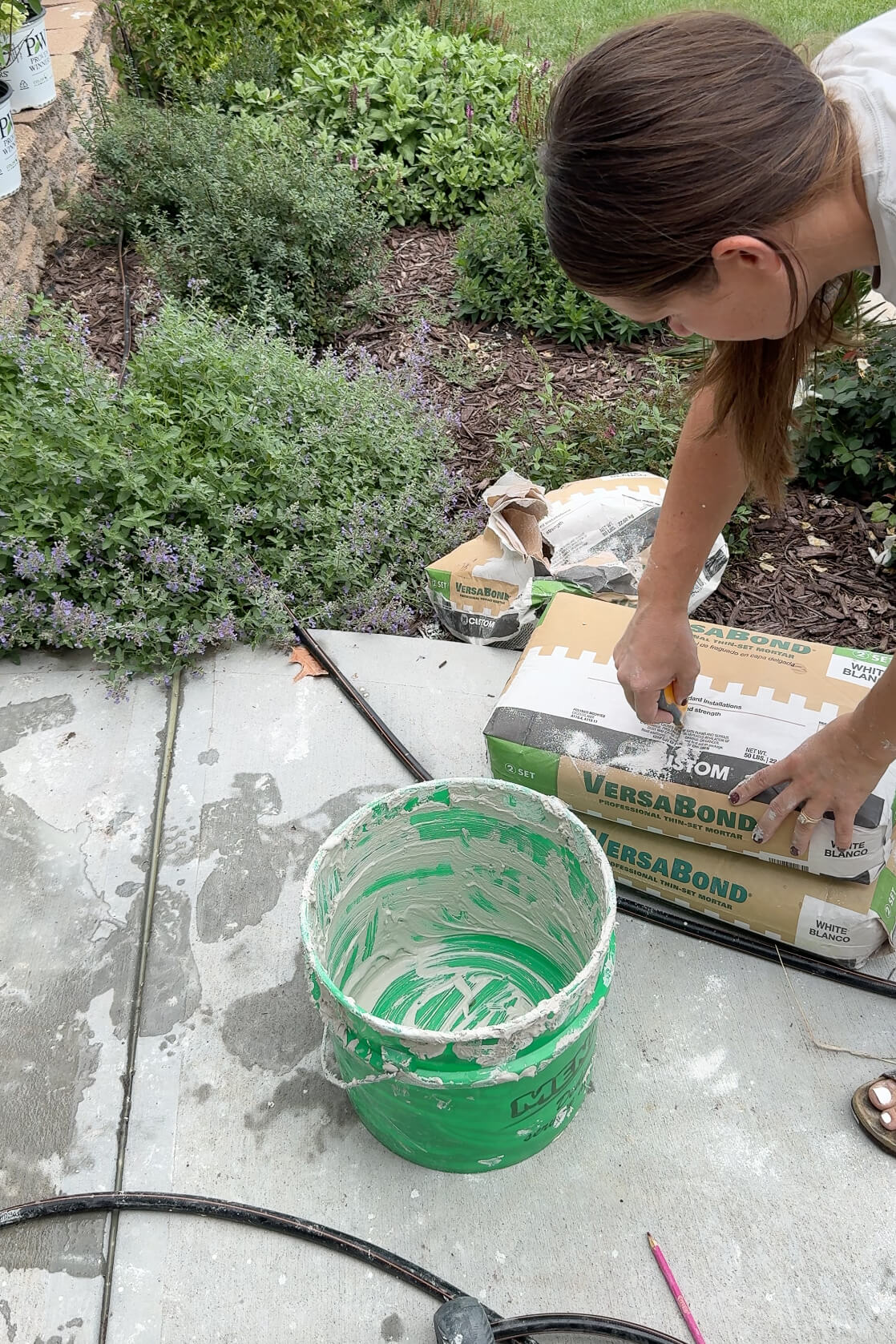 Mixing mortar to cover up and update an old rock wall.